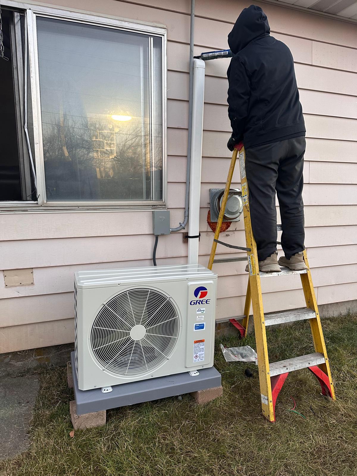 Mountain Star technician installing a new outdoor AC condenser unit